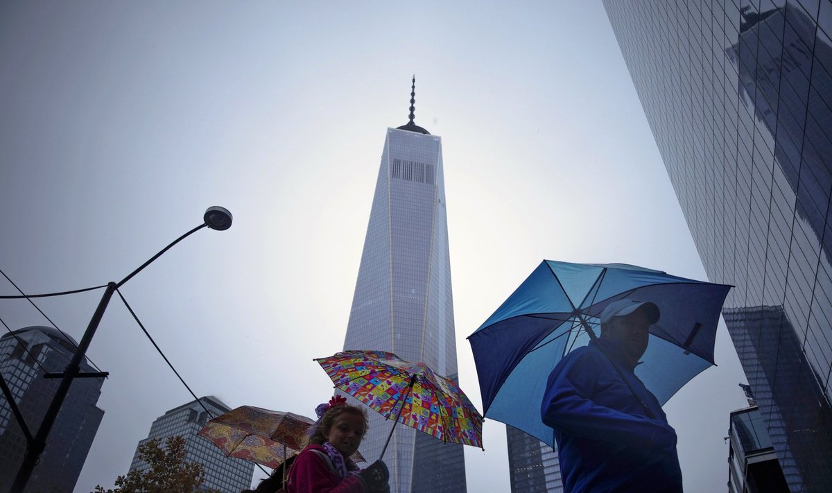 People walk next to the One World Trade Center in New York