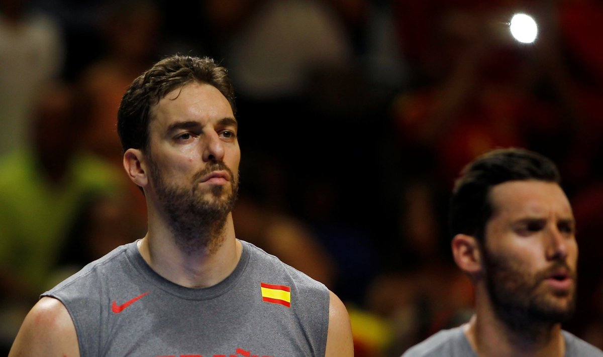 Spain's Gasol and Rudy listen to national anthems during a friendly basketball game against Lithuania as part of their training for the 2016 Rio Olympic games, in Malaga