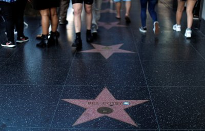 People walk by the Star of actor Bill Cosby on the Walk of Fame in Los Angeles