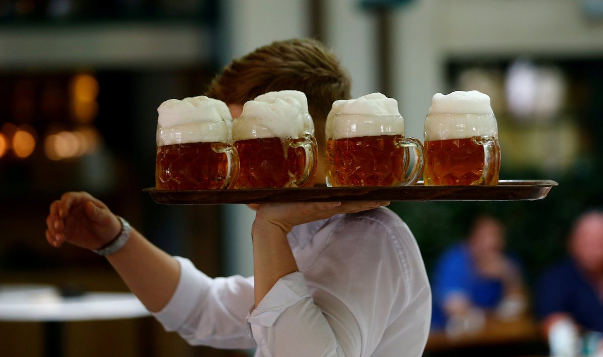 FILE PHOTO: A waiter serves beer in the traditional Schweizerhaus beer garden in Vienna