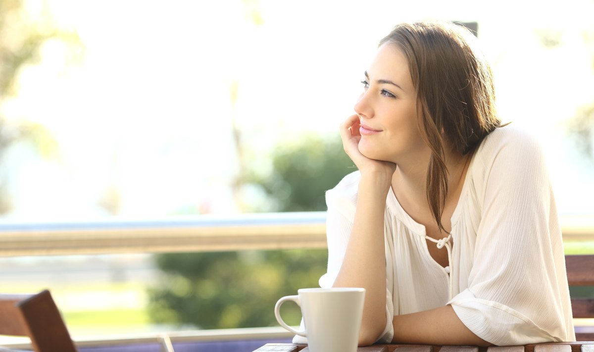 Pensive happy woman remembering