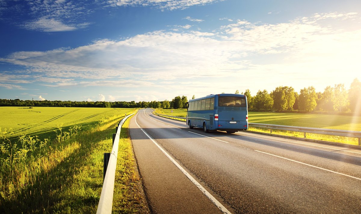 Bus on asphalt road in beautiful spring day at countryside