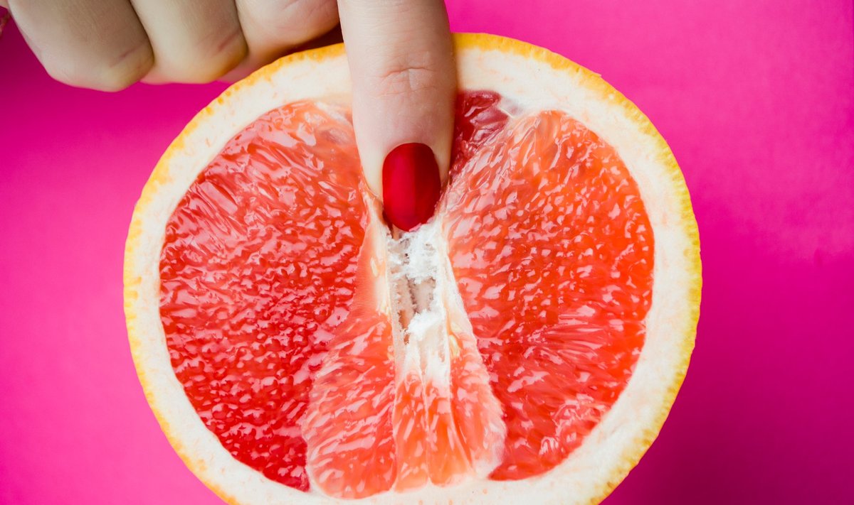 Vagina,Symbol.,Two,Fingers,On,Grapefruit,On,Pink,Background.,Sex