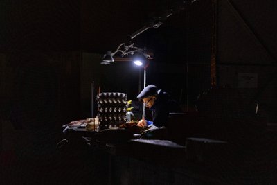 A seller waits for customers at the Bessarabsk market in the center of Kyiv despite another power outage.