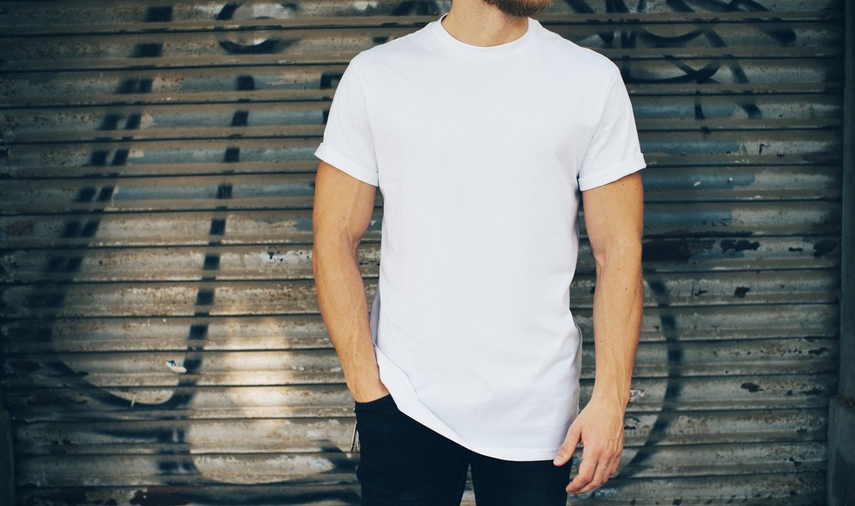 Young,Man,Wearing,White,Blank,T-shirt,And,Blue,Jeans,,Standing