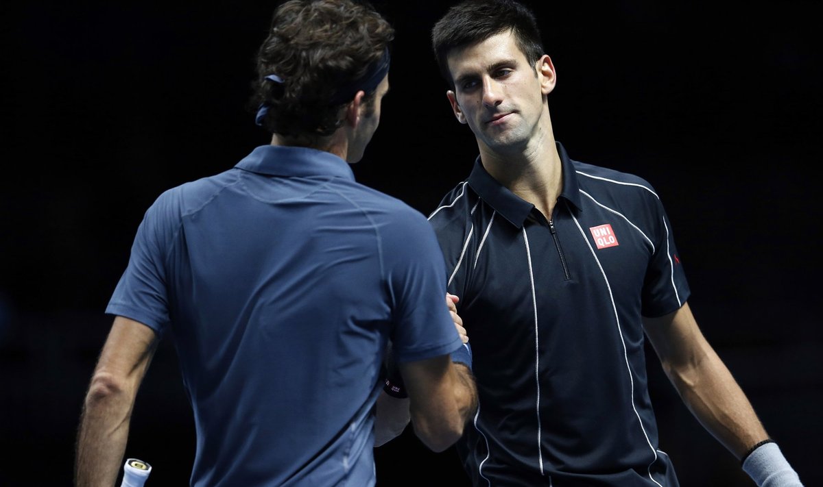 Djokovic of Serbia shakes hands with Federer of Switzerland following their men's singles tennis match at the ATP World Tour Finals at the O2 Arena in London