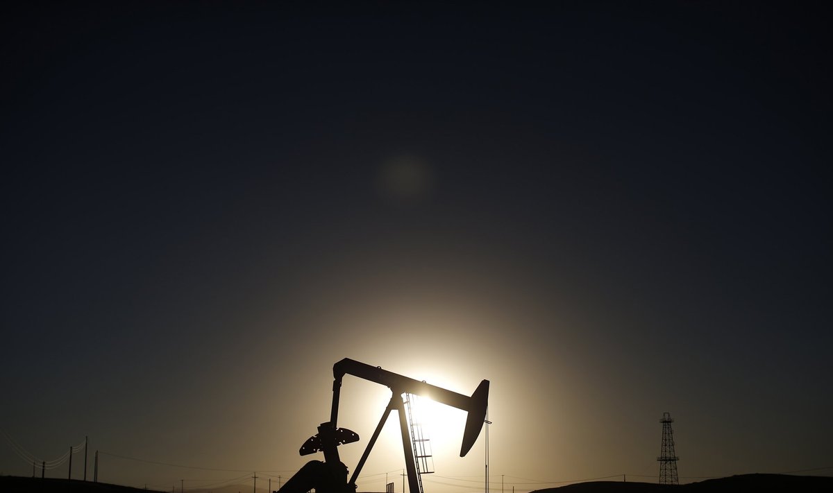 An oil derrick is seen at sunrise near Bakersfield