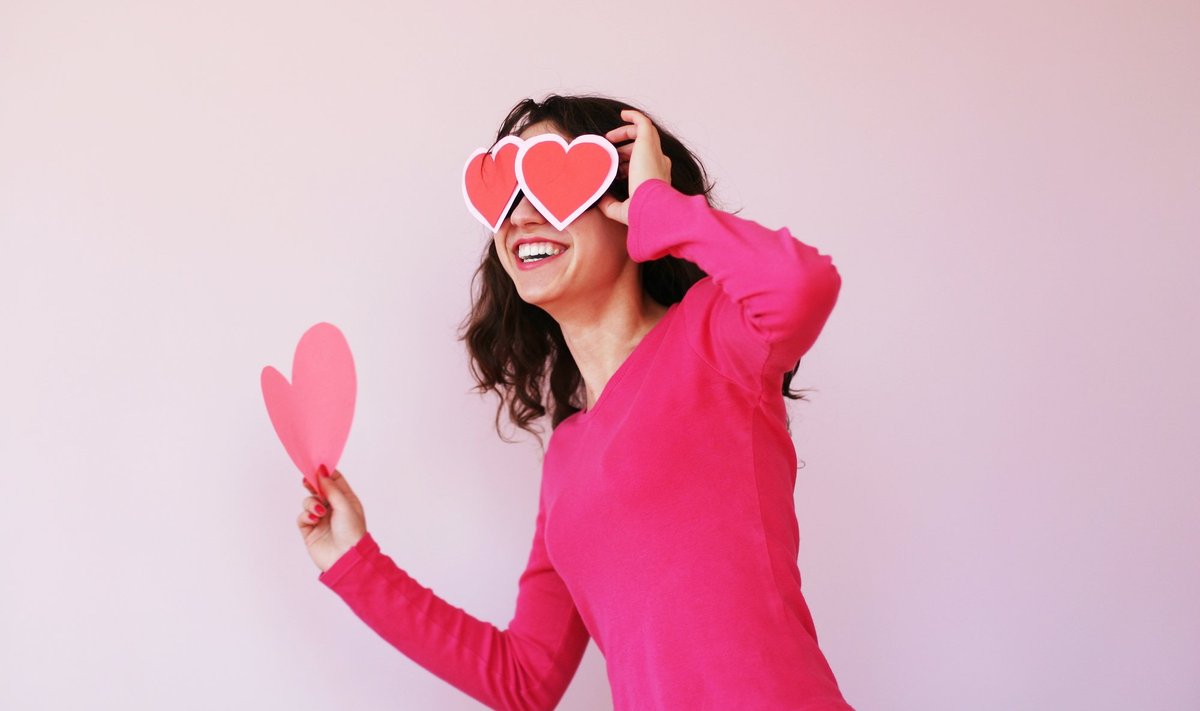 Beautiful,Young,Woman,In,Heart-shaped,Glasses,Caught,In,Jump,Motion
